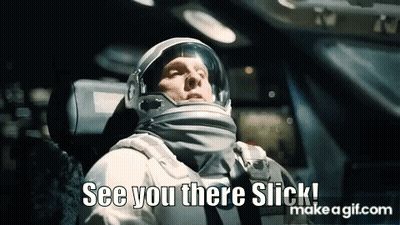 A Man In An Astronaut 'S Helmet Is Sitting In A Car And Says `` See You There Slick '' . GIF