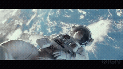 A Man In An Astronaut 'S Suit Is Floating In The Air GIF