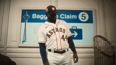 a man in an astros uniform is standing in front of a sign that says bagge claim 5