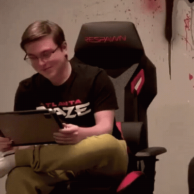 A Man In An Atlanta Blaze Shirt Is Sitting In A Chair GIF