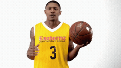 A Man In An Easterns Automotive Group Jersey Holding A Basketball GIF