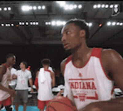 A Man In An Indiana Jersey Holds A Basketball In His Hands GIF