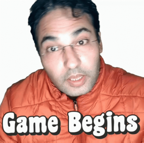 A Man In An Orange Jacket With The Words Game Begins Above Him GIF
