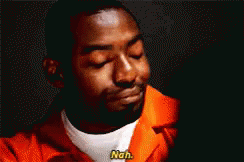 A Man In An Orange Jail Uniform Is Smiling And Says Nah . GIF