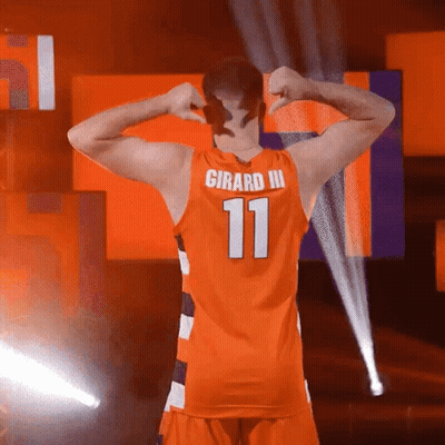 A Man In An Orange Jersey With The Number 11 On The Back GIF