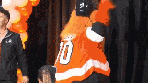 A Man In An Orange Jersey With The Number 70 On It GIF