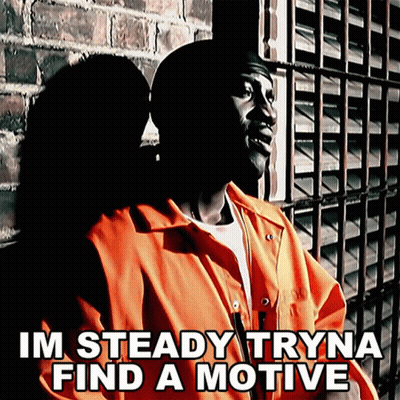 A Man In An Orange Jumpsuit Is Standing In Front Of A Brick Wall With The Words Im Steady Tryna Find A Motive Below Him GIF