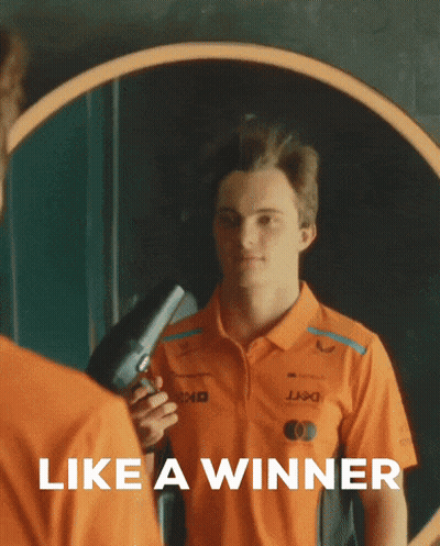 A Man In An Orange Shirt Holds A Hair Dryer In Front Of A Mirror With The Words Like A Winner Below Him GIF