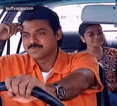 A Man In An Orange Shirt Is Driving A Car With A Woman Sitting In The Back Seat . GIF