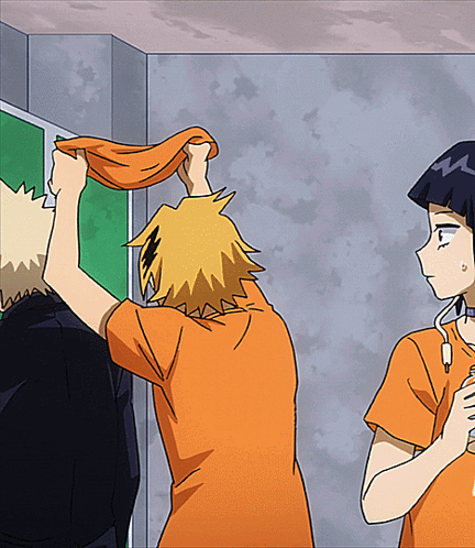 A Man In An Orange Shirt Is Holding A Towel Over His Head While Another Man Looks On GIF
