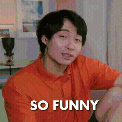 A Man In An Orange Shirt Is Making A Funny Face With The Words So Funny Below Him GIF