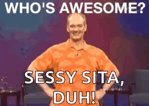 A Man In An Orange Shirt Is Standing With His Hands On His Hips And Says Who 'S Awesome ? Sassy Sita Duh ! GIF
