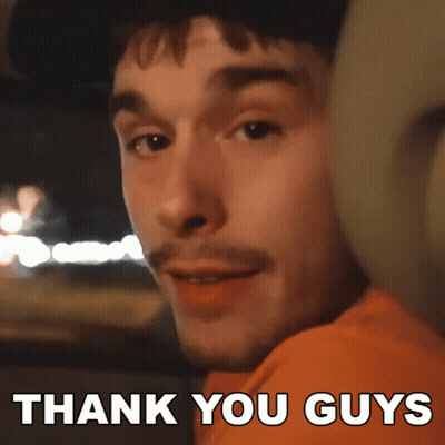 A Man In An Orange Shirt Says Thank You Guys In White Letters GIF