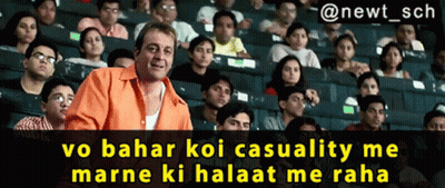 A Man In An Orange Shirt Stands In Front Of A Crowd Of People With The Caption " @Newt_sch GIF