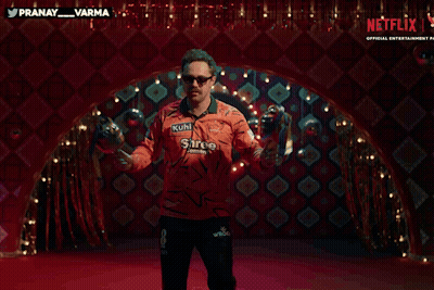 A Man In An Orange Shirt That Says Kuhl On It Is Dancing GIF