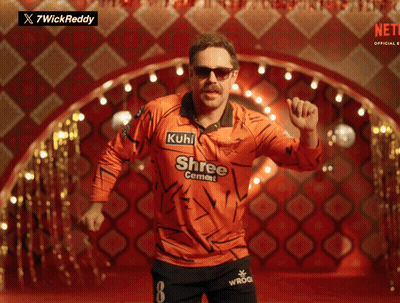 A Man In An Orange Shirt That Says Shree Cement On It GIF