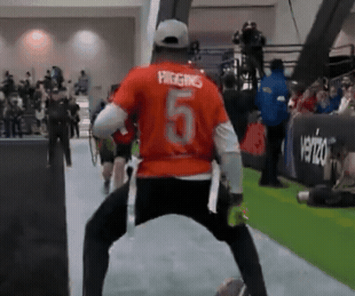 A Man In An Orange Shirt With The Number 5 On The Back GIF