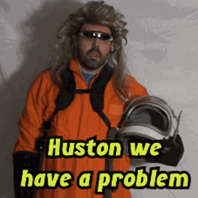 A Man In An Orange Suit Holding A Helmet With The Words Huston We Have A Problem GIF