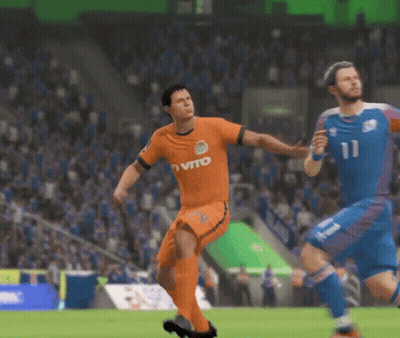 A Man In An Orange Vito Jersey Is Kicking A Ball GIF