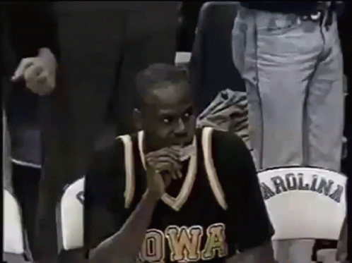A Man In An Owa Jersey Sits In A Carolina Chair GIF