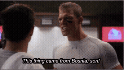 A Man In An Under Armour Shirt Talks To Another Man In A Locker Room And Says This Thing Came From Bosnia Son GIF