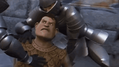 A Man In Armor Is Being Attacked By A Group Of Robots . GIF