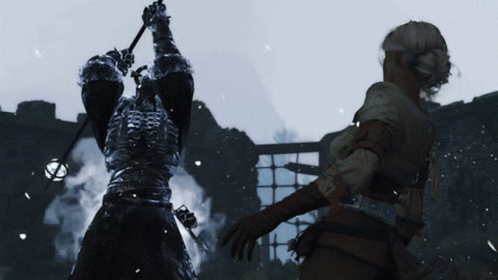 A Man In Armor Is Holding A Sword Above His Head While A Woman Stands Behind Him GIF
