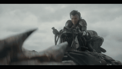 A Man In Armor Is Riding On The Back Of A Dragon .. GIF