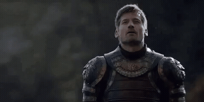 A Man In Armor Is Standing In Front Of A Forest Looking Up . GIF