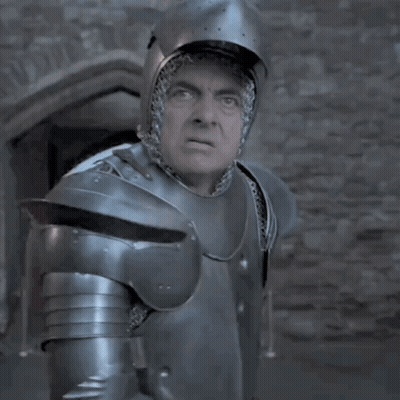 A Man In Armor Is Standing In Front Of A Window GIF