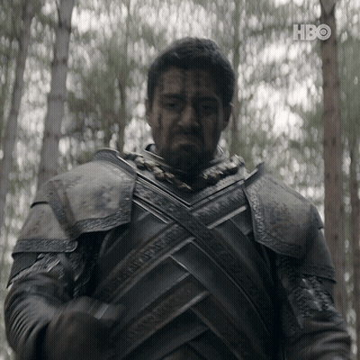 A Man In Armor Is Standing In The Woods With A Hbo Logo In The Background GIF
