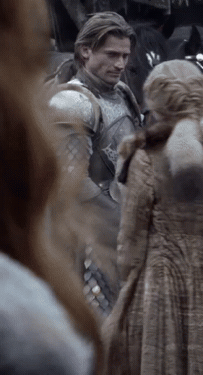 A Man In Armor Is Standing Next To A Woman GIF