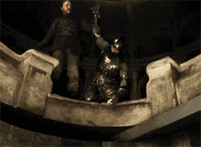 A Man In Armor Is Standing On A Ledge Holding A Sword GIF