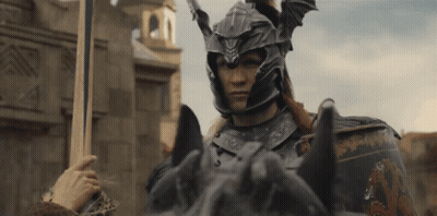 A Man In Armor Riding A Horse With A Sword In His Hand GIF