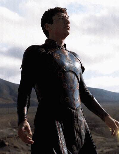A Man In Armor Stands In A Desert Looking Up At The Sky GIF