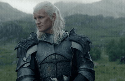 A Man In Armor Stands In A Grassy Field GIF