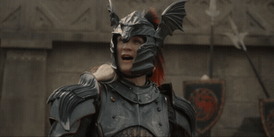 A Man In Armor With His Arms Outstretched Is Laughing GIF