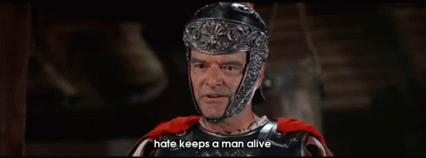 A Man In Armor With The Words Hate Keeps A Man Alive GIF