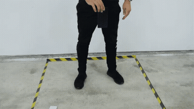 A Man In Black Pants Is Standing In A Yellow And Black Line GIF