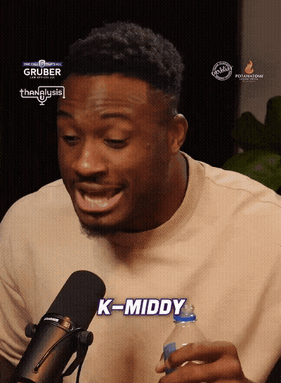 A Man In Front Of A Microphone With The Words K-Middy Written On The Bottom GIF