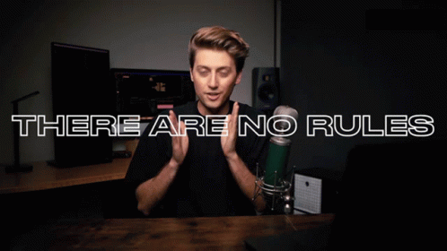 A Man In Front Of A Microphone With The Words There Are No Rules GIF