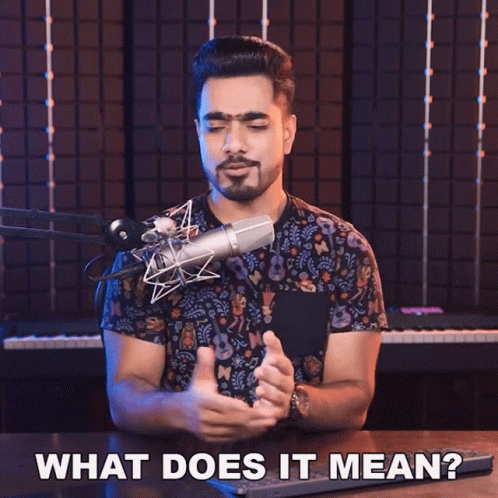 A Man In Front Of A Microphone With The Words What Does It Mean Below Him GIF