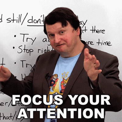 A Man In Front Of A White Board That Says Focus Your Attention On It GIF