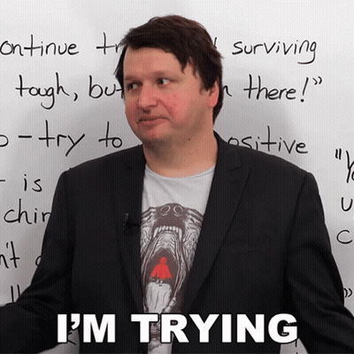 A Man In Front Of A White Board That Says I 'M Trying On It GIF