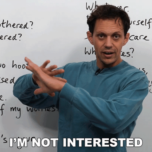 A Man In Front Of A White Board With The Words I 'M Not Interested GIF