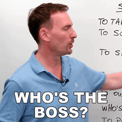 A Man In Front Of A White Board With The Words Who 'S The Boss Written On It GIF