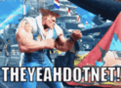 A Man In Overalls And A Hat Is Standing In Front Of A Flag With The Words Theyeahdotnet . GIF