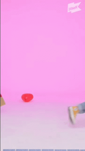 A Man In Overalls And A Yellow Hat Is Holding A Broom In His Hand . GIF