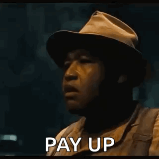 A Man In Overalls Is Holding Out His Hand With The Words Pay Up Written On It GIF