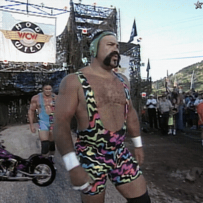 A Man In Overalls Stands In Front Of A Sign That Says Wow GIF